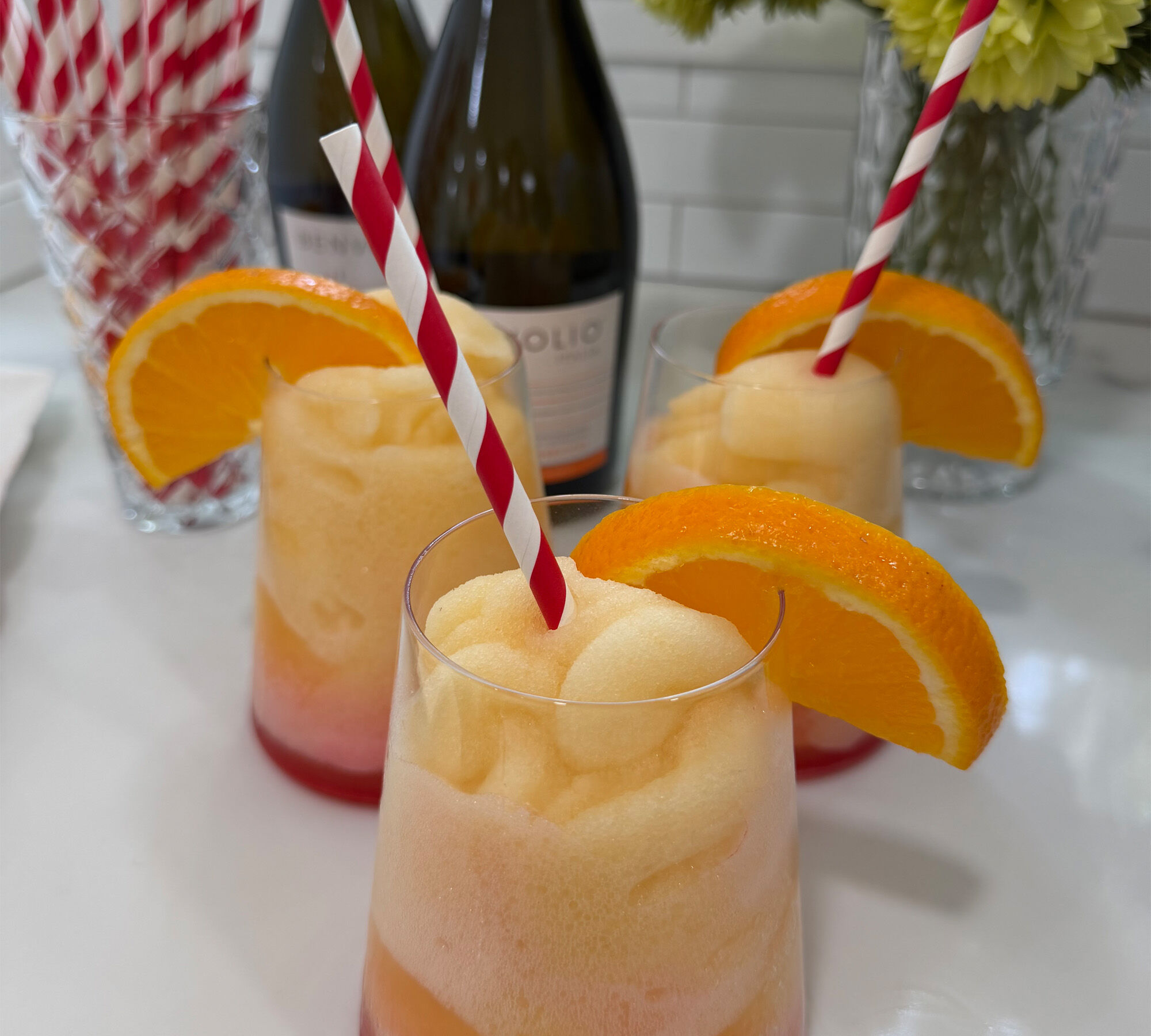 Frozen mimosa in a glass with an orange slice